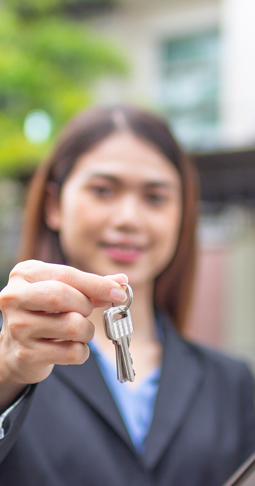 Young Real Estate agent holding keys
